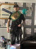 Man standing inside own living room with birthday present Custom Color Tech Championship 2.0 Belt - Green Belt / Gold Plates