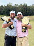 Two friends on the green with their custom golf themed Championship 2.0 Belts - Black Belt / Gold Plates 